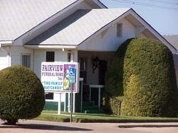 Church building with a sign for fairview funeral home and chapel on the lawn