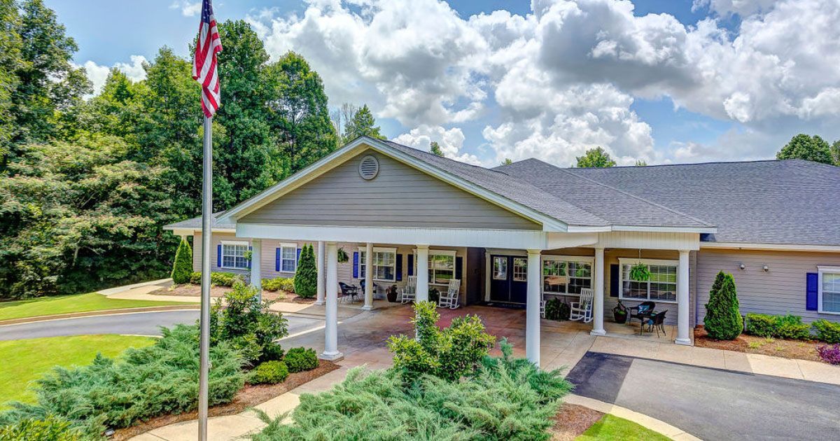 A large house with a flag flying in front of it.