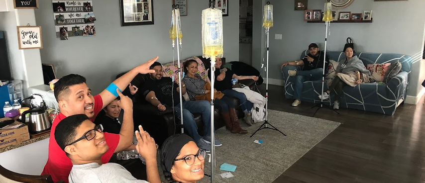 Group of people receiving mobile IV drip therapy at home