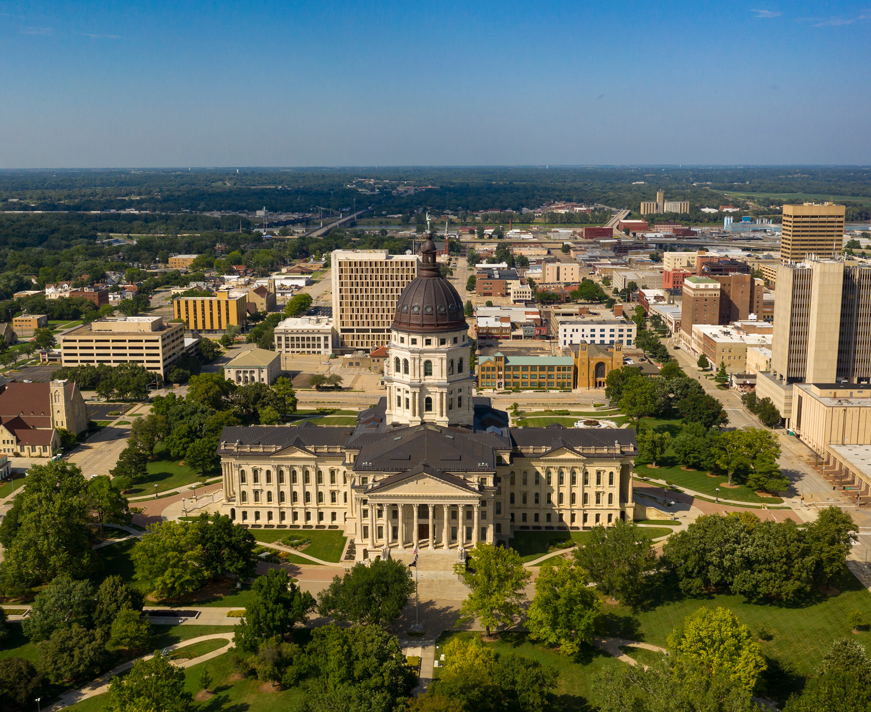 Aerial view of state capitol building and surrounding city skyline