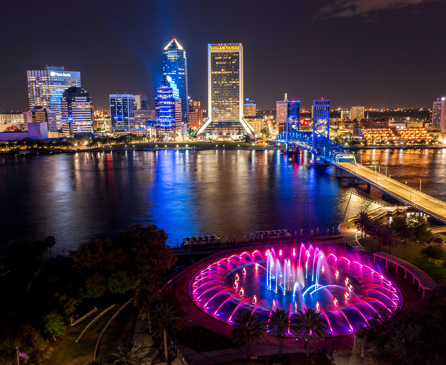 Downtown Jacksonville Florida skyline and Friendship Fountain illuminated at night