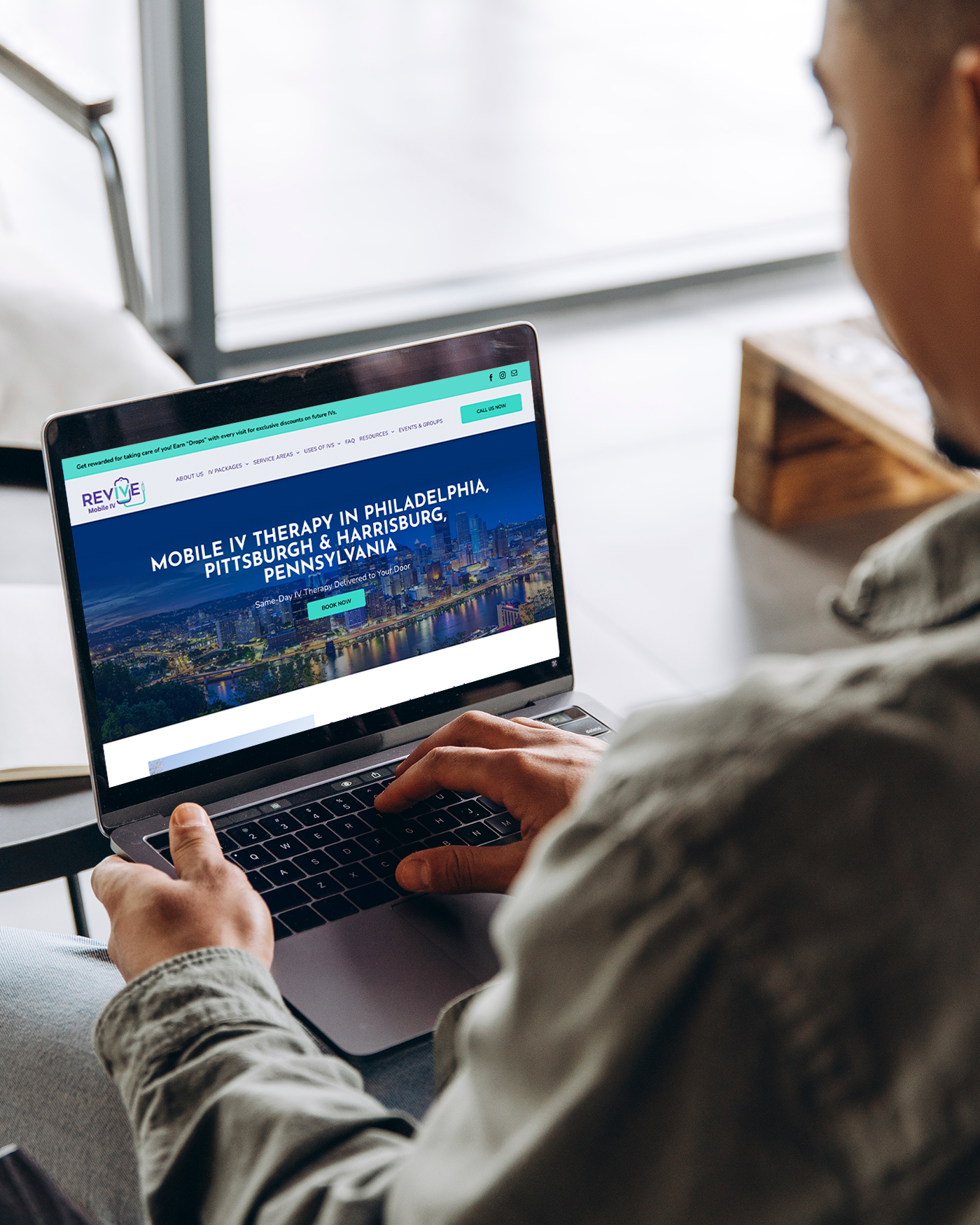 A laptop and a cell phone are displaying a website for mobile iv therapy in oklahoma.