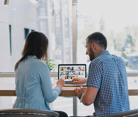 Two colleagues working together on a laptop