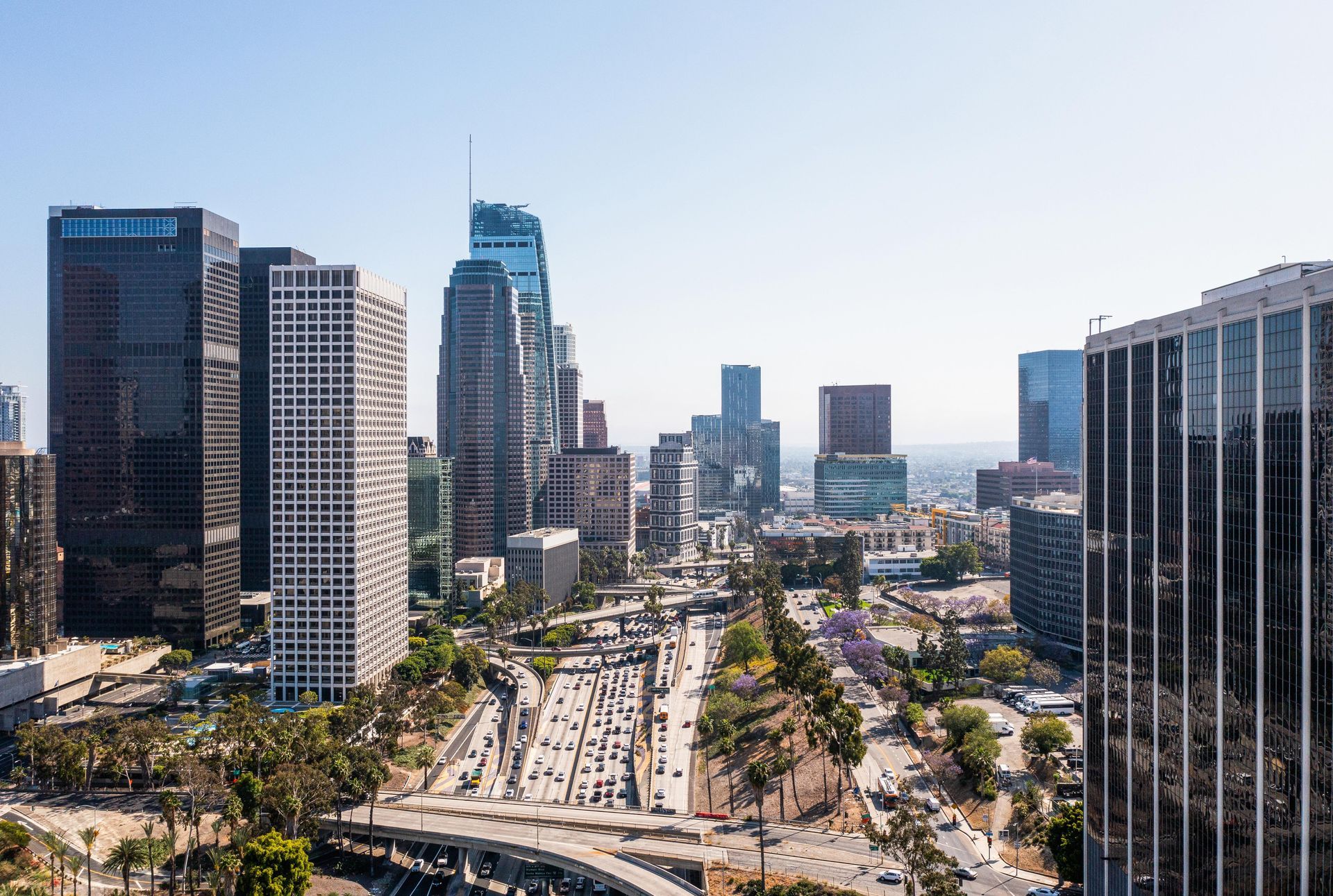 Aerial view of city skyscrapers and highway traffic