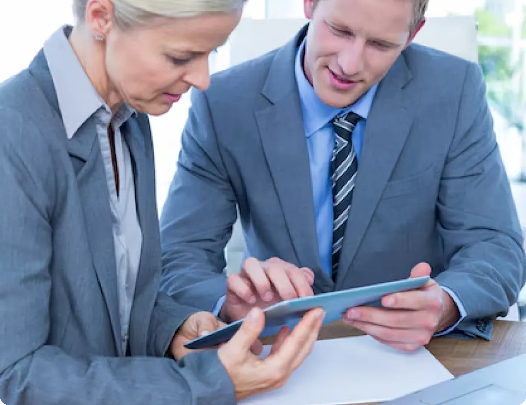 A man and a woman are looking at a tablet together