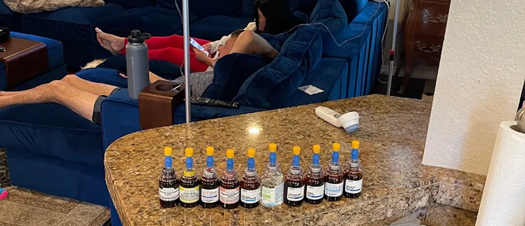 Row of IV vitamin and supplement vials lined up on a counter during in-home IV therapy