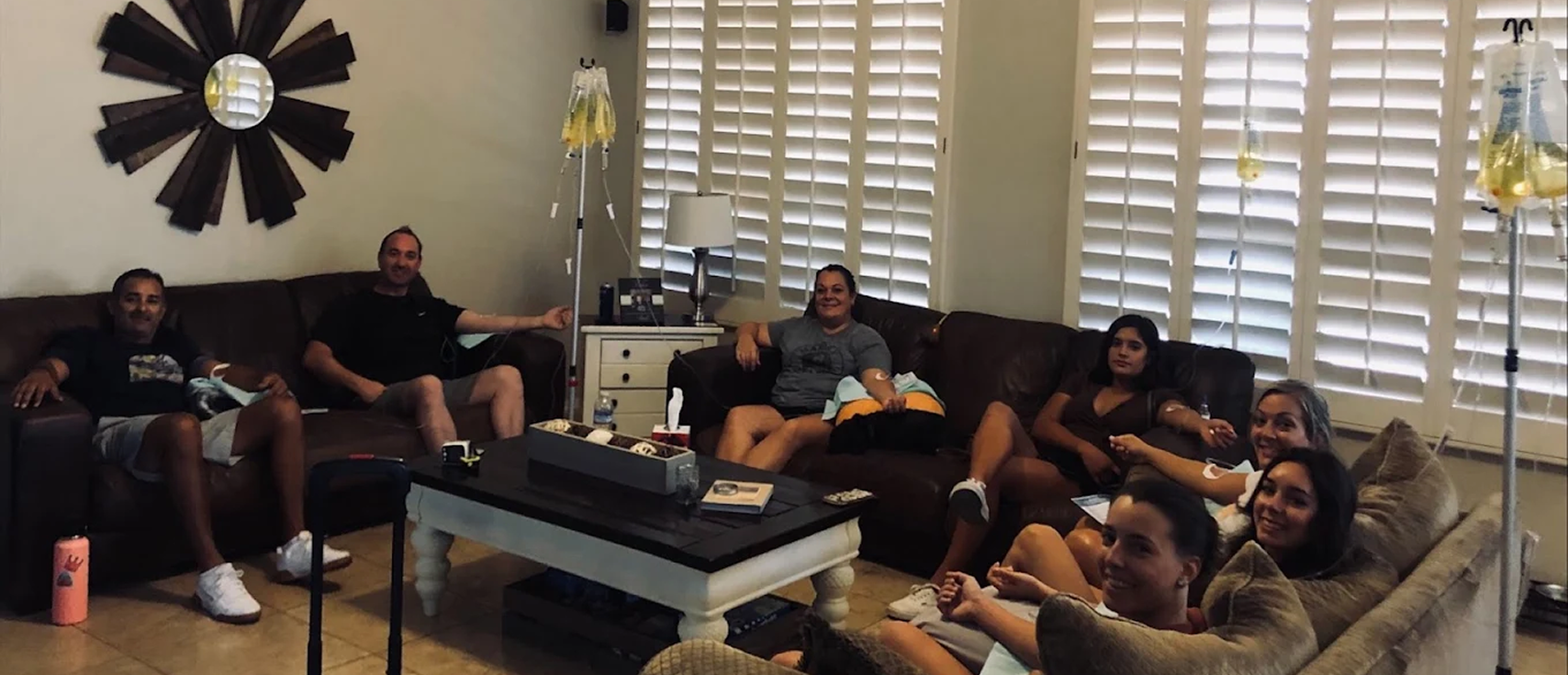 Group of people receiving mobile IV therapy in living room