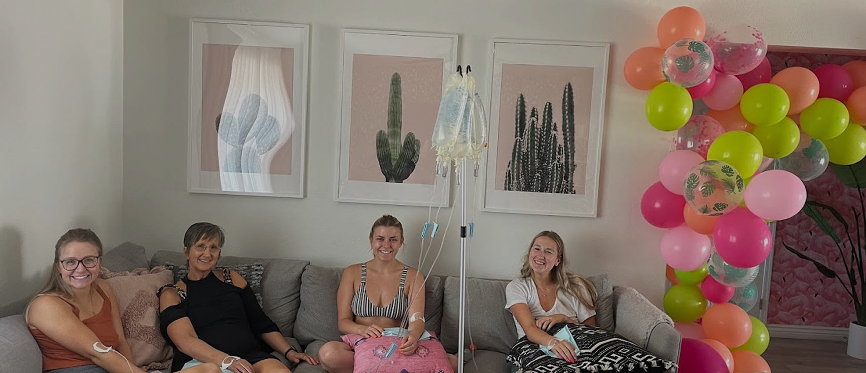 Group of women receiving mobile IV therapy together at a party
