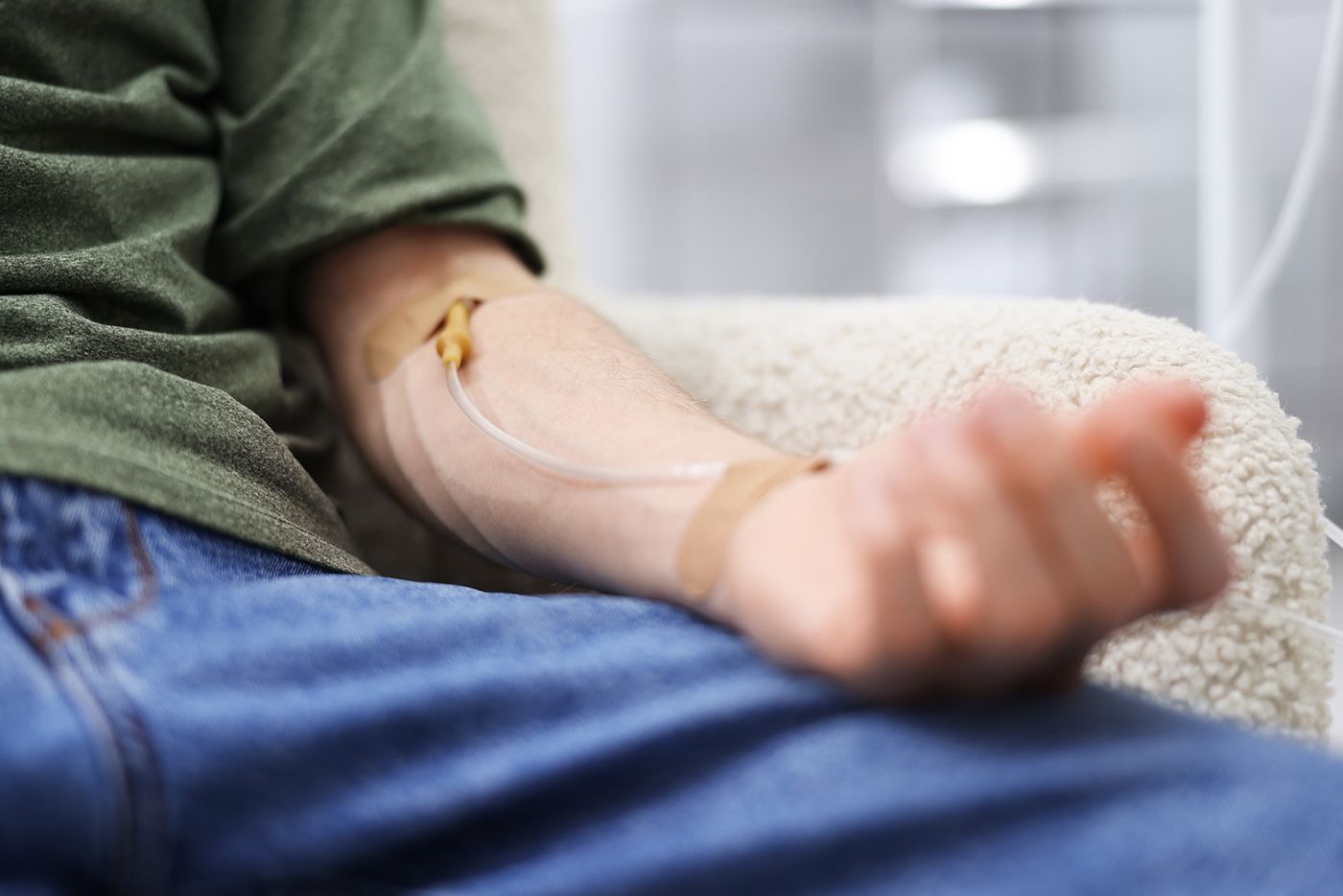 Close-up of man receiving IV drip therapy in arm