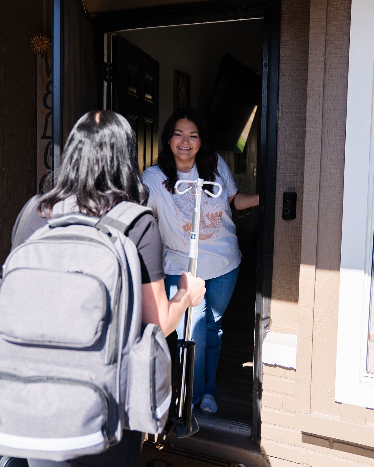 Mobile IV nurse arriving at a client's front door for home visit