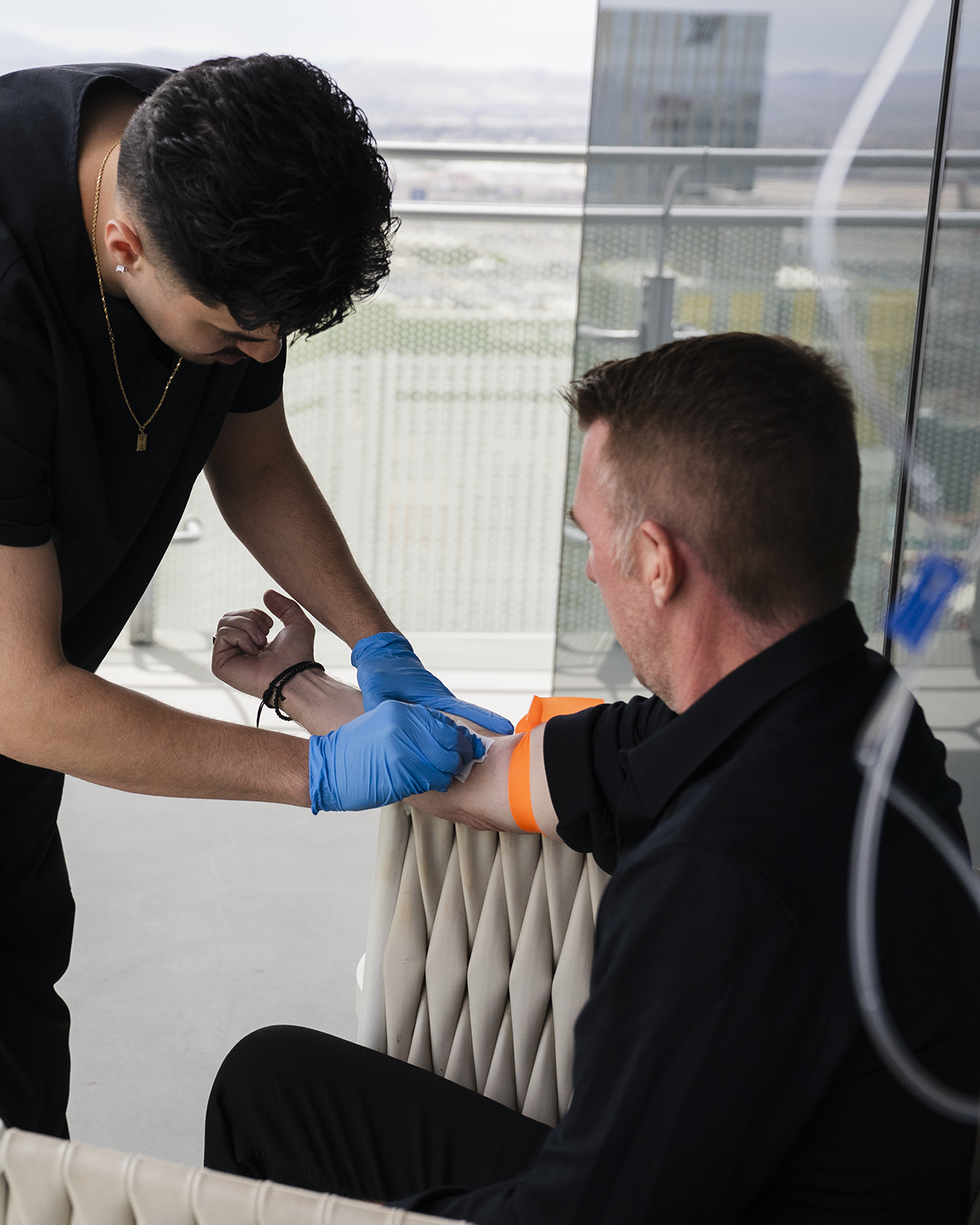 Nurse preparing patient arm for IV drip treatment
