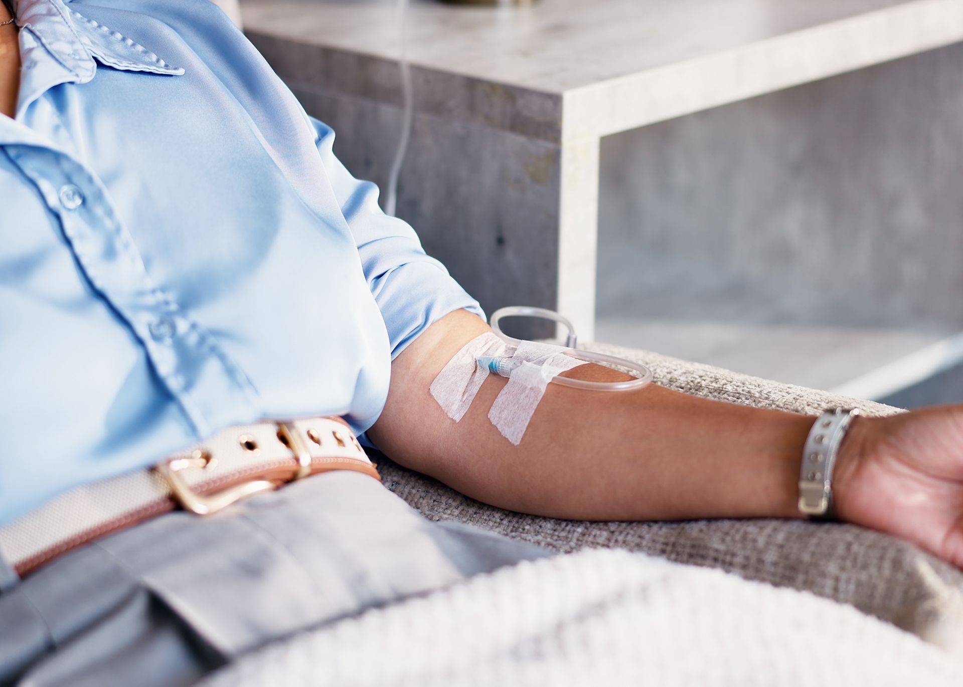 Patient receiving IV drip therapy in arm