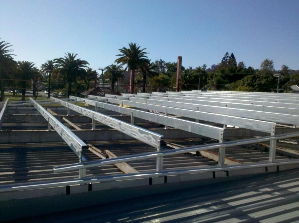 The Roof of a Building is Being Built With Palm Trees in the Background — North Coast Steel Fabrication in South Lismore, NSW