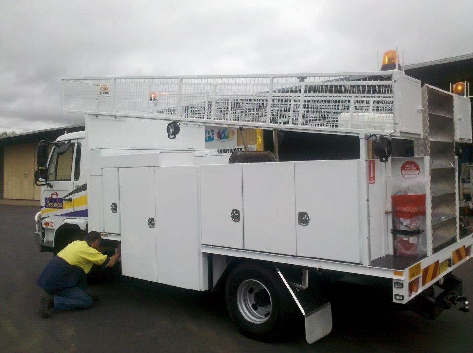 A Man is Working on the Side of a White Truck — North Coast Steel Fabrication in South Lismore, NSW