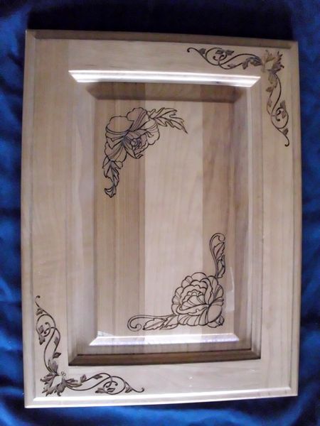 A wooden picture frame with a floral design on it