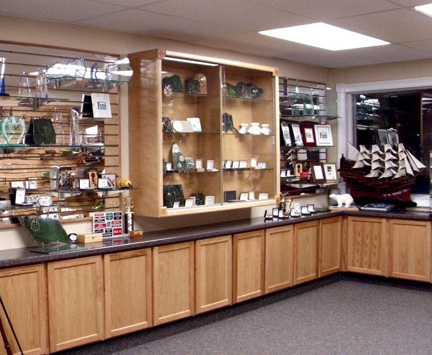 A room with a lot of shelves and a ship on the counter
