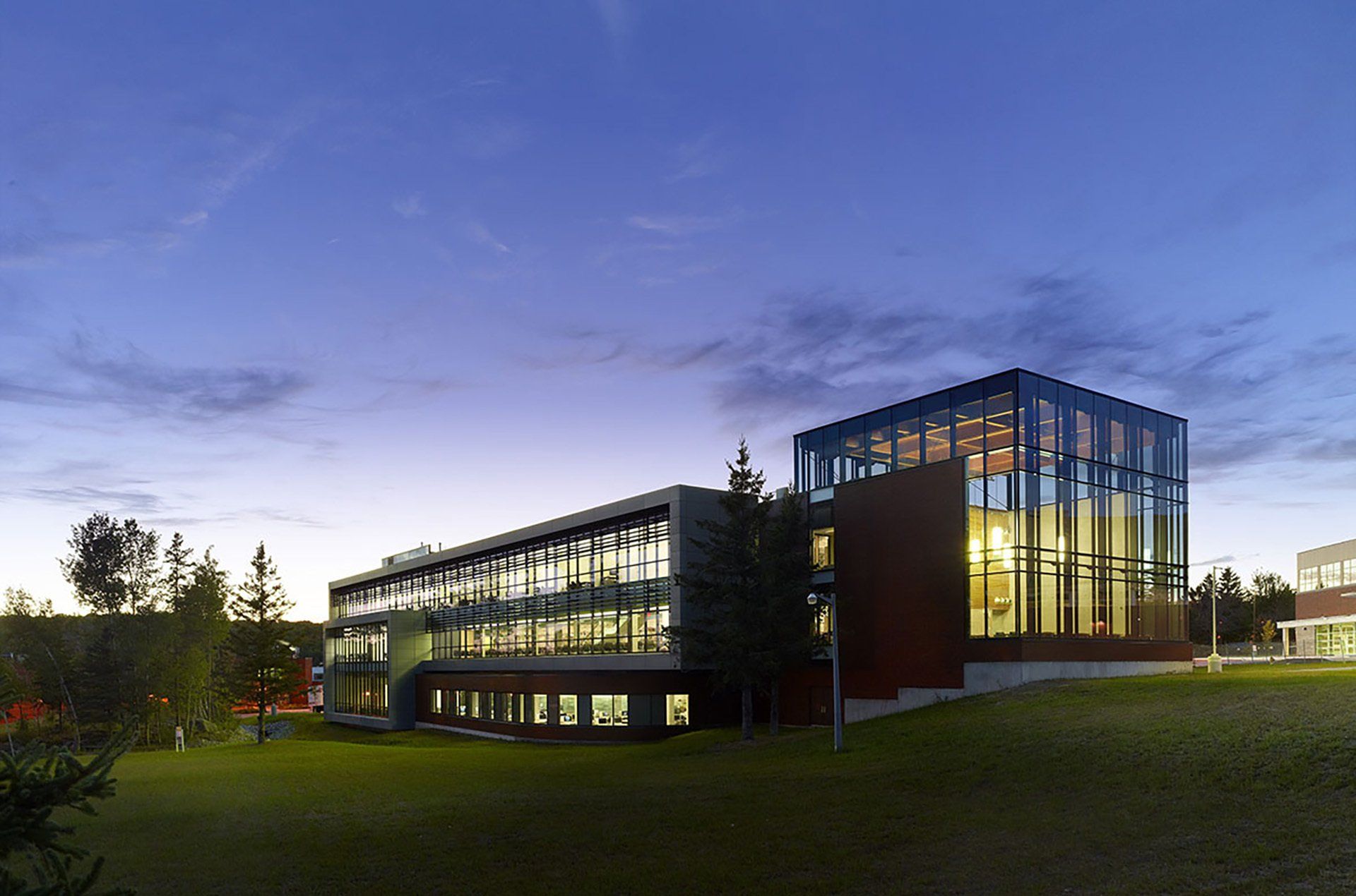 A large building with a lot of windows is lit up at night