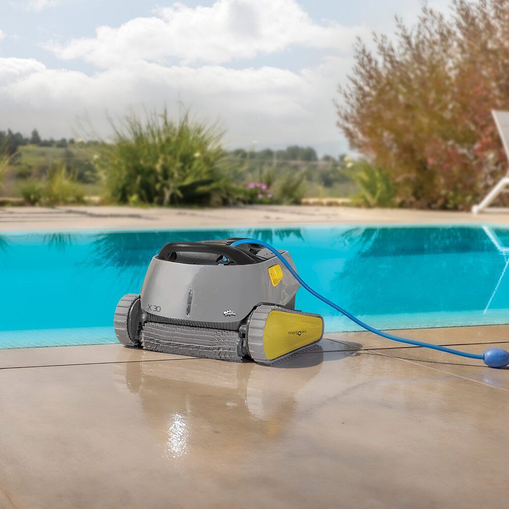 A Robotic Pool Cleaner Is Sitting on The Edge of A Swimming Pool — Poolside Noosa in Noosaville, QLD