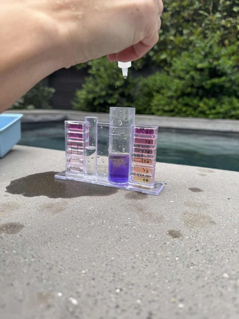 A Person is Pouring Liquid Into a Test Tube — Poolside Noosa in Noosaville, QLD