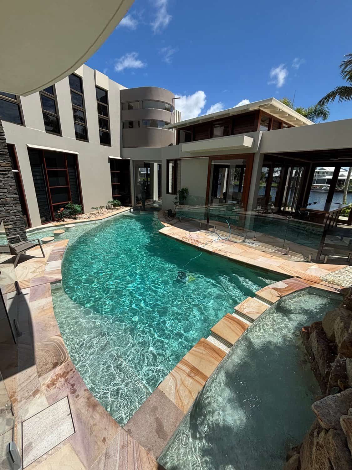 A Large Swimming Pool in Front of a Large House — Poolside Noosa in Noosaville, QLD