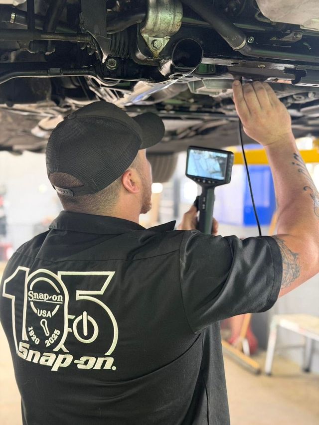Auto Technician Inspecting Vehicle Undercarriage | ProDrive Auto Care