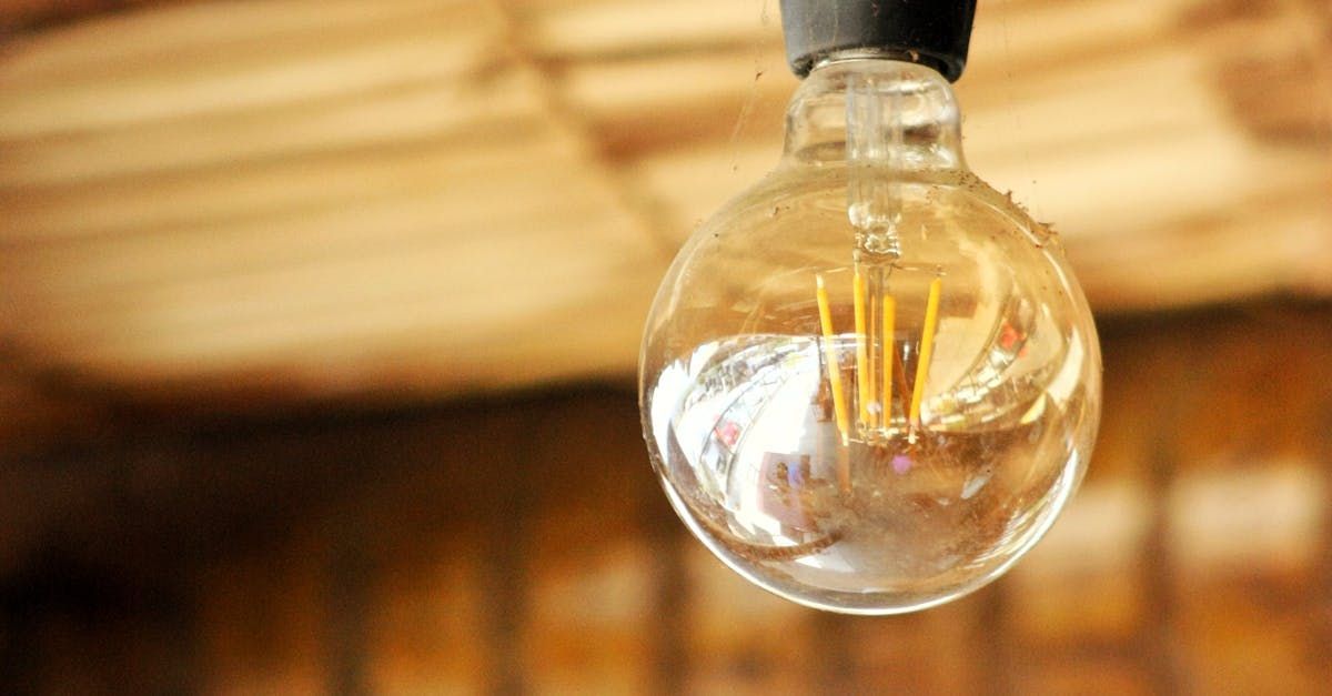 A close up of a light bulb hanging from the ceiling.