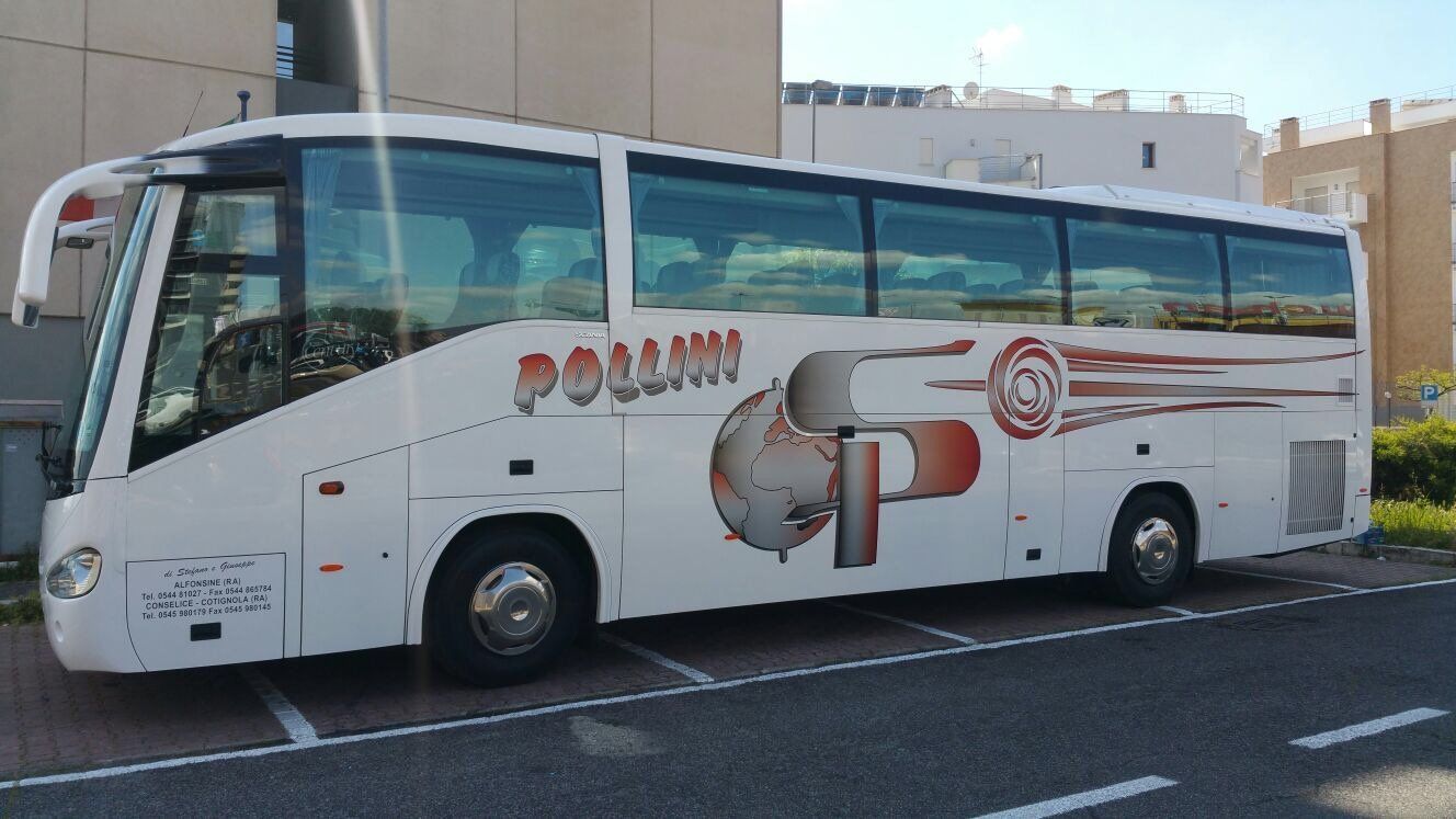White Pollini bus parked in front of a building.