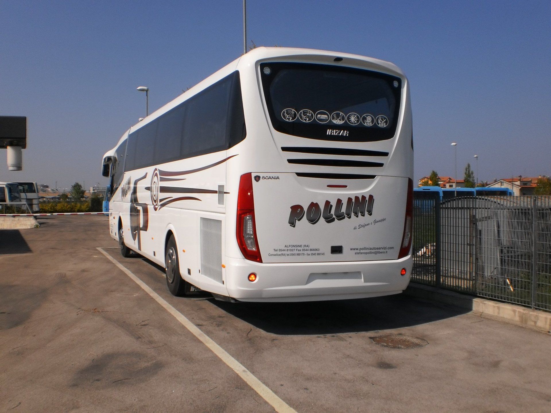 White bus parked in a car park, with the word