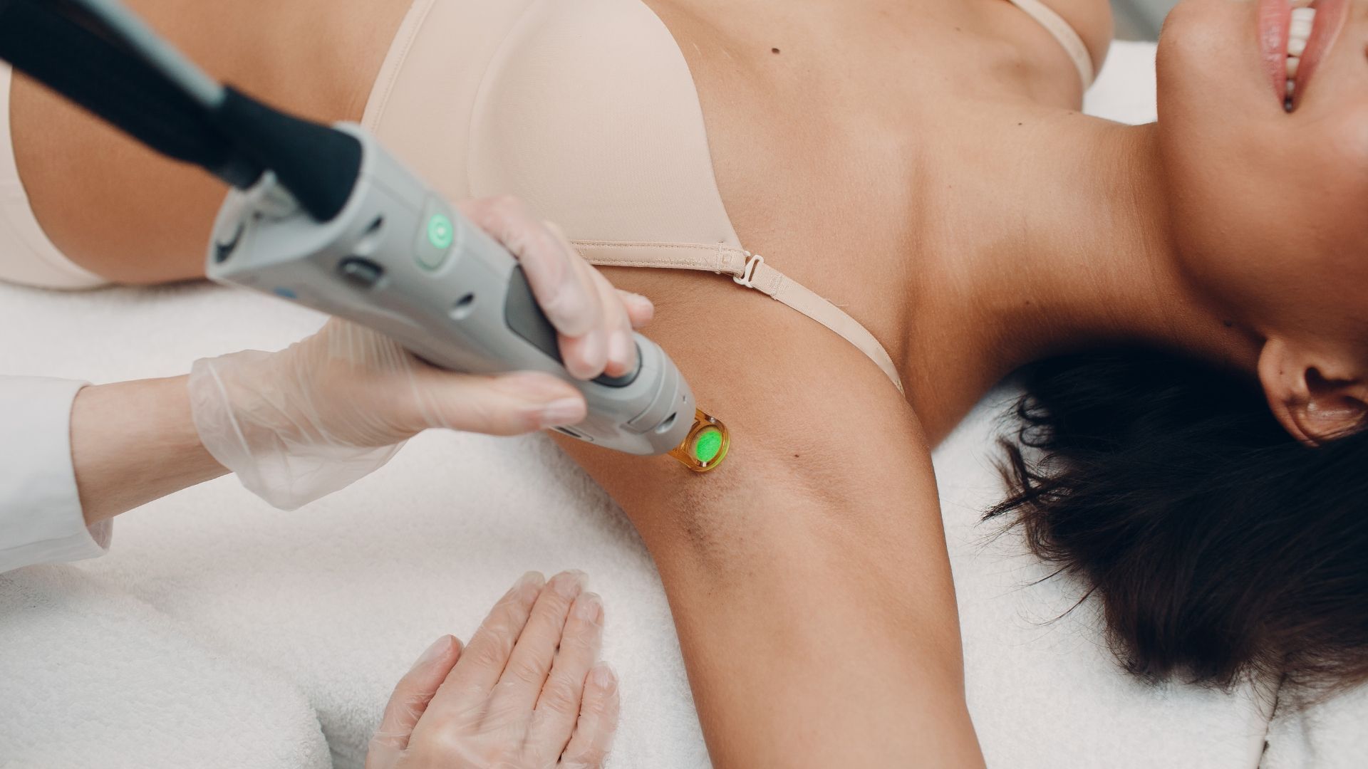 A woman is getting a laser hair removal treatment on her arm.