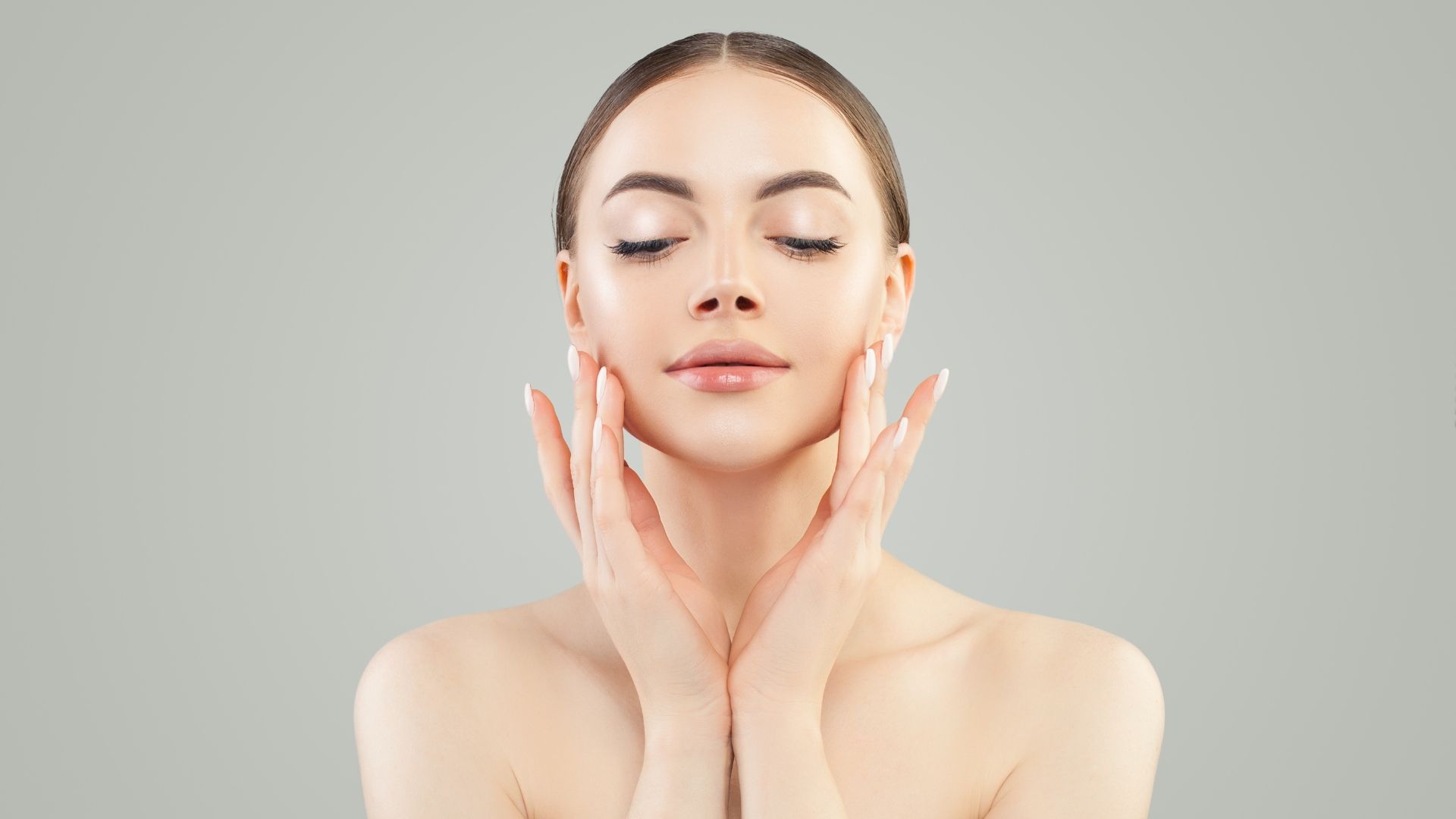 a model with beautiful skin framing her face with her hands