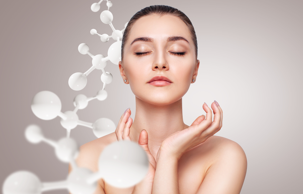 A woman with her eyes closed and a molecule coming out of her face.