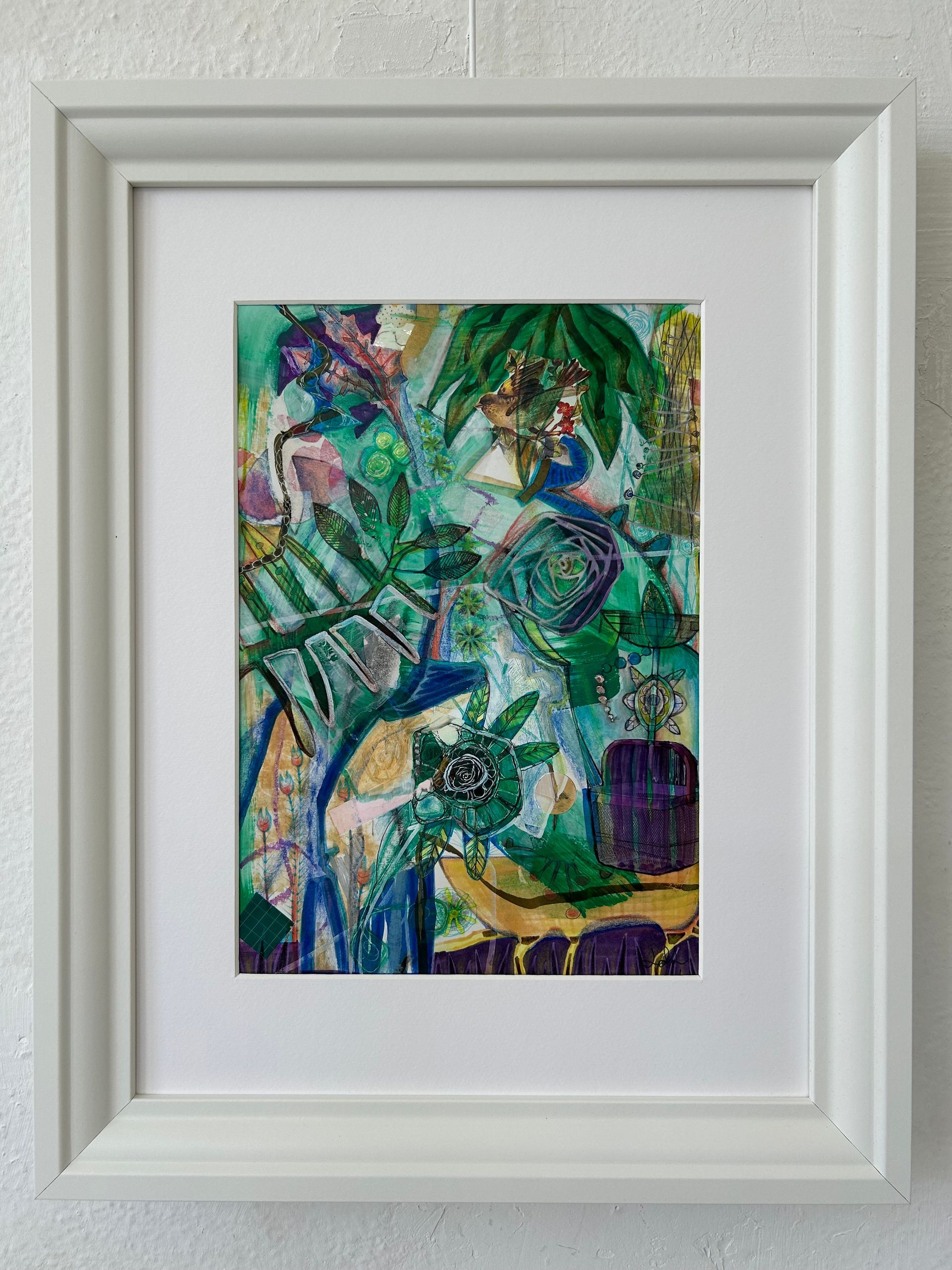 Abstract schilderij in groen en blauw van weelderige bladeren in een witte lijst.