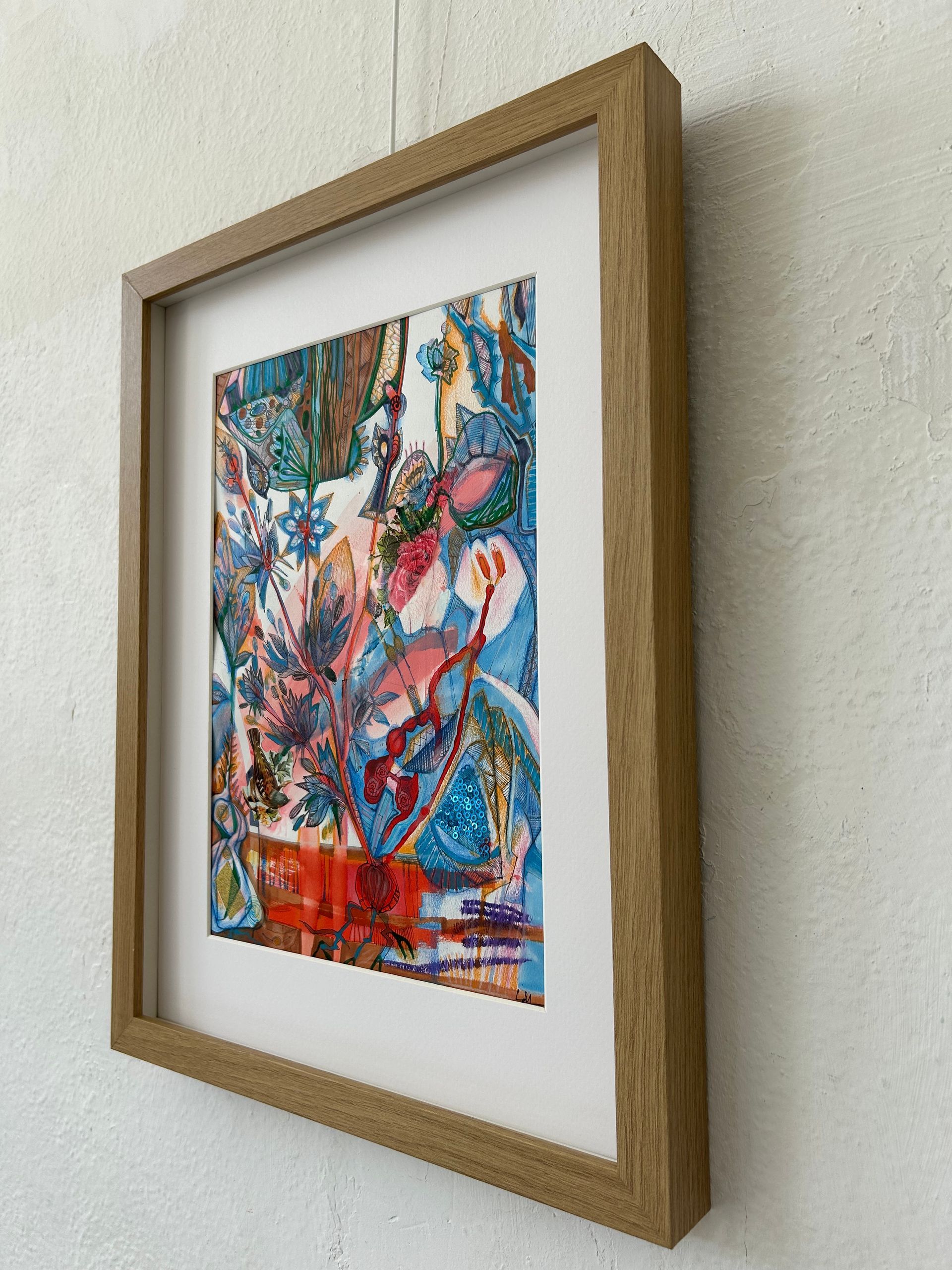 Ingelijst abstract, kleurrijk kunstwerk met witte passe-partout, hangend aan een muur met structuur.