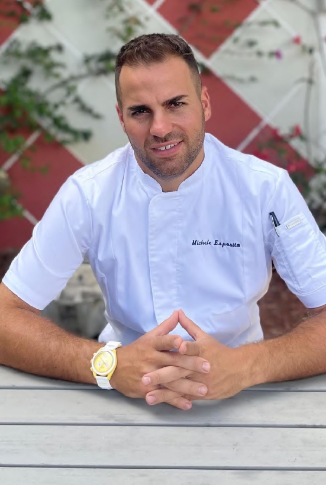 Michele Esposito, executive Chef at the Harbour Club, sitting at a table.