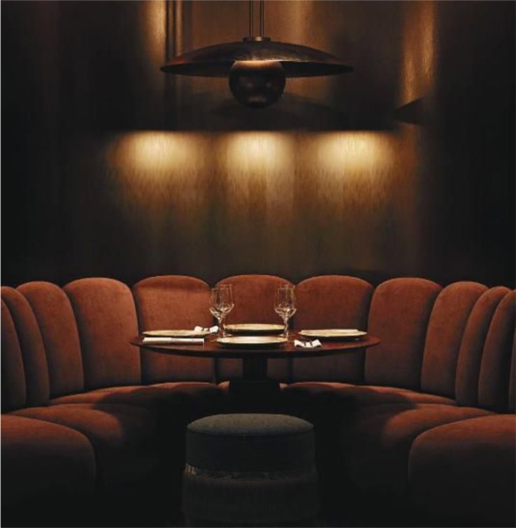 A table with plates and wine glasses in a dark room