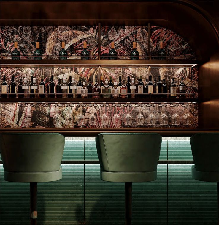 A bar with two chairs and a shelf full of bottles and glasses.