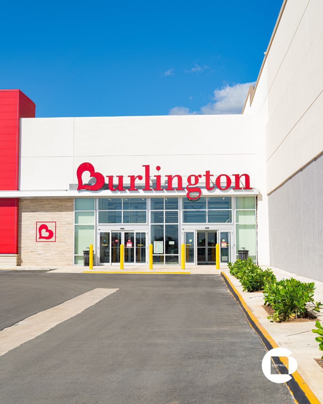 Burlington store sign on a red building under a cloudy sky