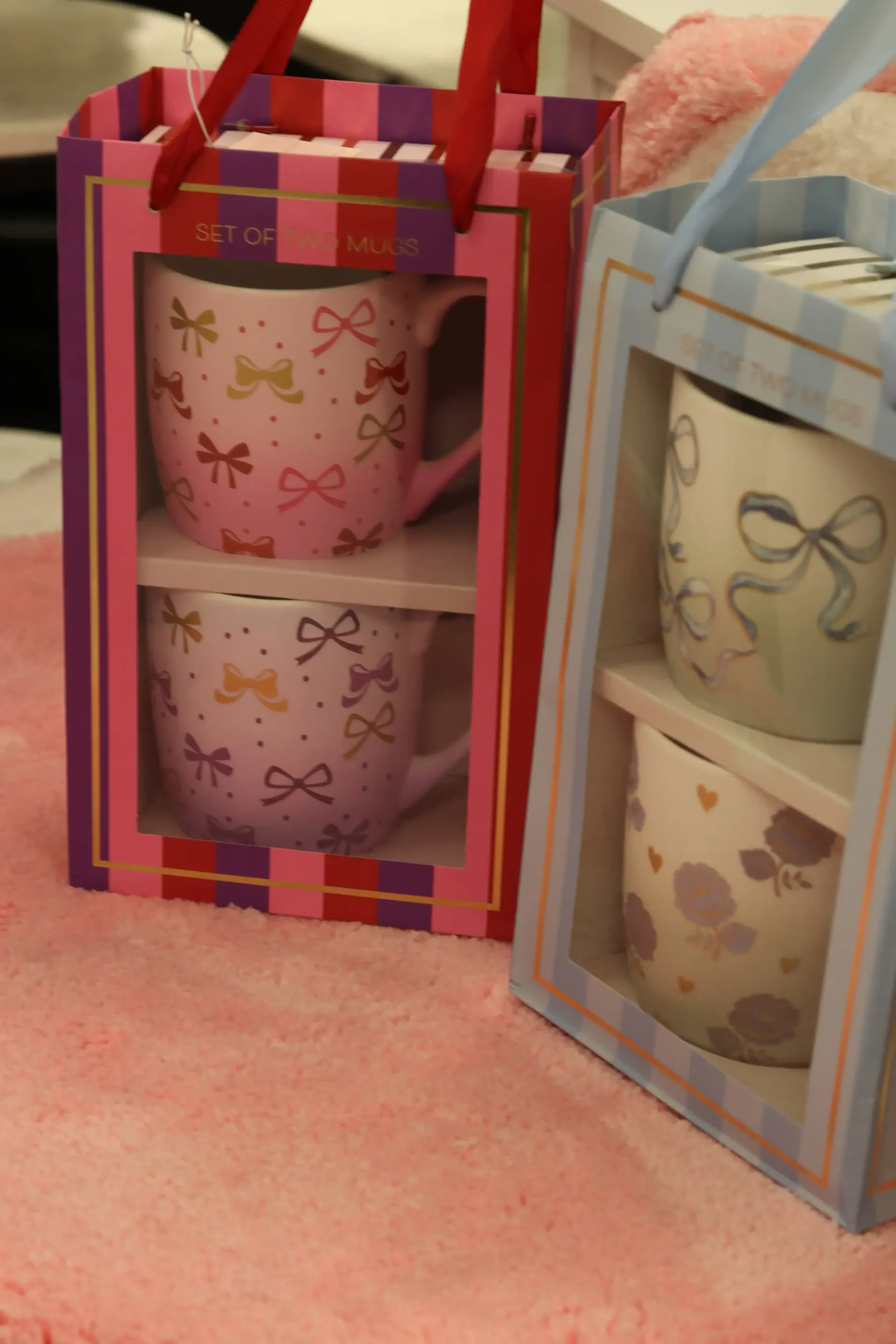 Two boxes of coffee mugs with bows on them