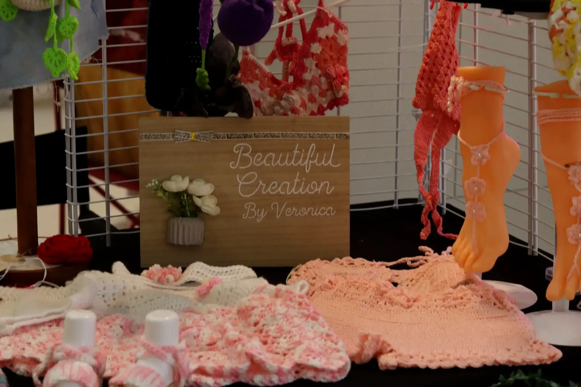 Crocheted clothing and accessories on display at a craft fair in Céntrico Guayama