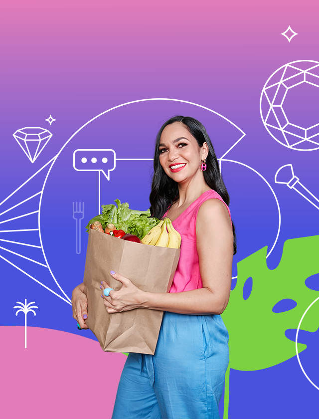 Woman with dark hair in a pink top and blue pants carries a grocery bag filled with produce. Céntrico Guayama
