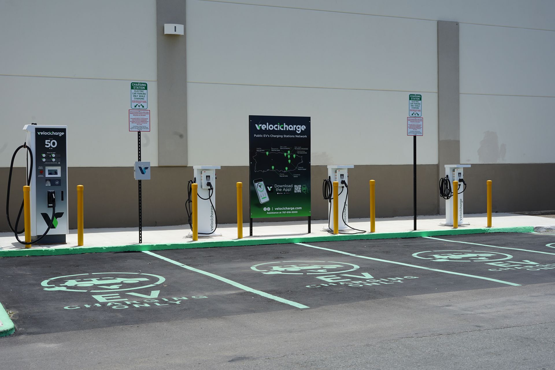 EV charging stations in designated parking spaces with signage and green markings.