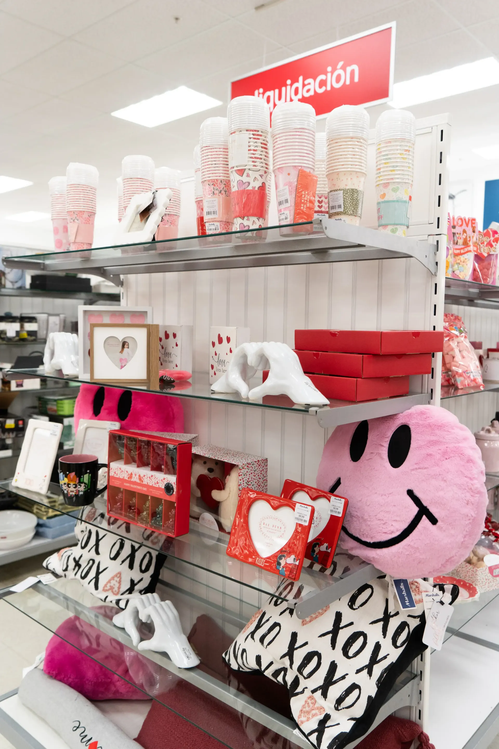 A shelf in a store filled with valentine 's day items.