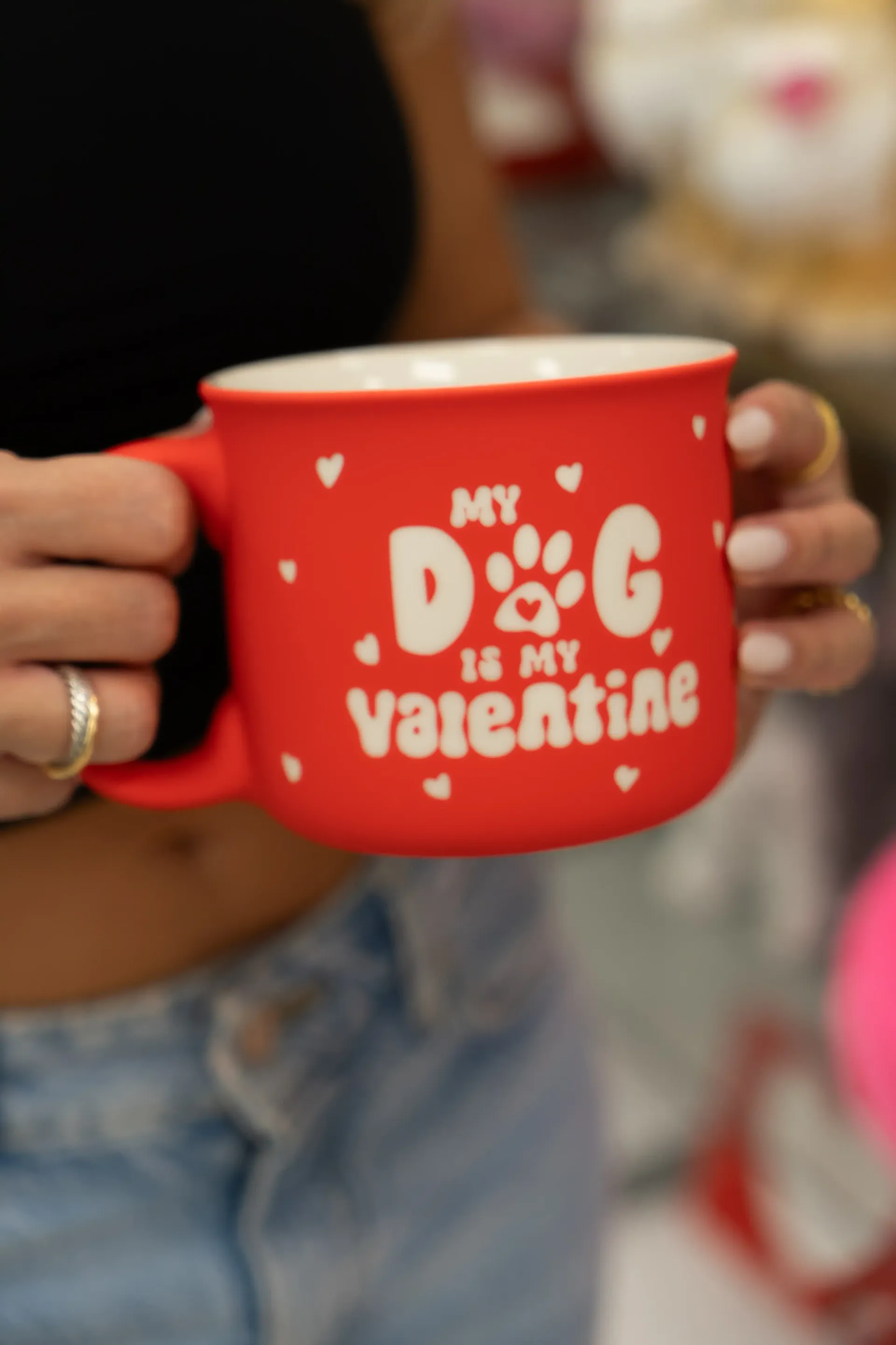 A woman is holding a red mug that says my dog is my valentine