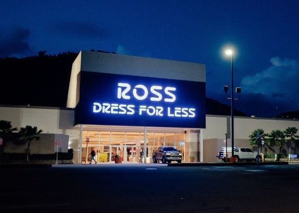 Ross Dress for Less store at night, bright sign glowing over the entrance and parking lot