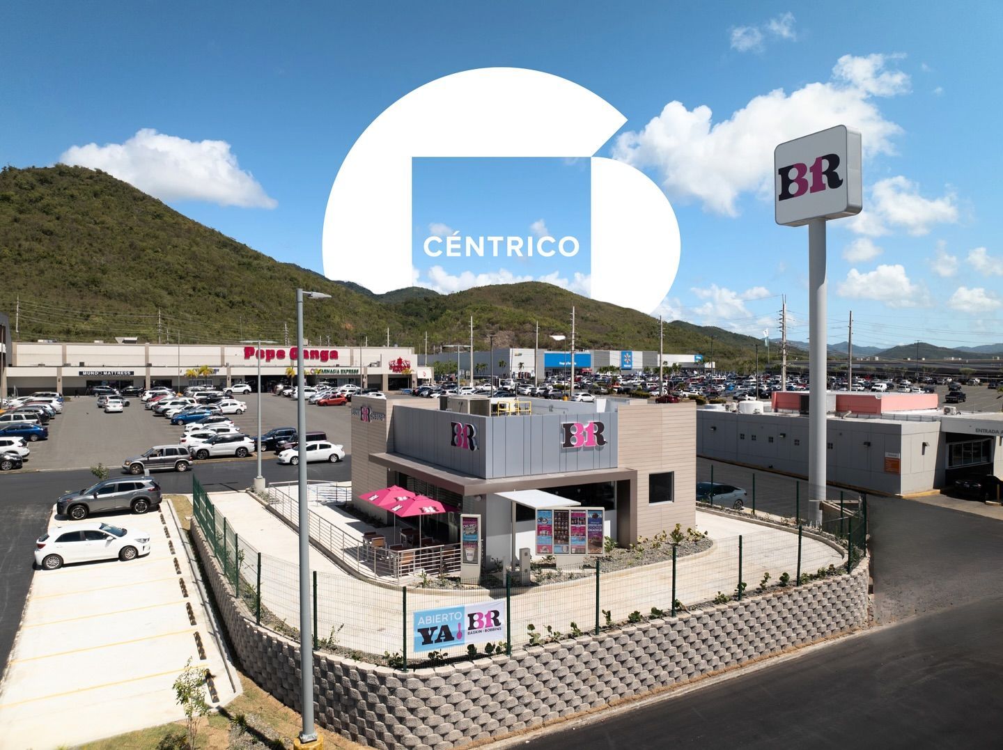 An aerial view of a céntrico store with mountains in the background