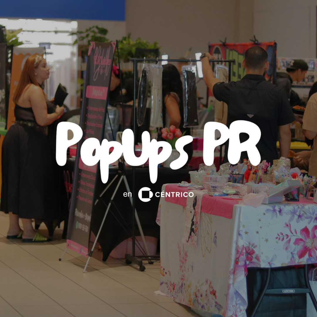 People browsing at an event with vendor stalls and