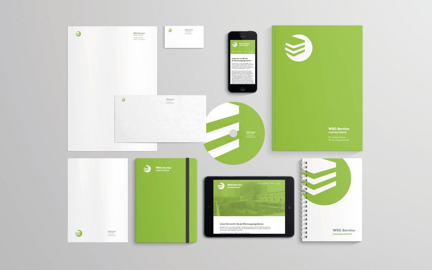 Corporate branding, green and white stationery: letterhead, envelope, business card, phone, pad, notebook, tablet, and CD.