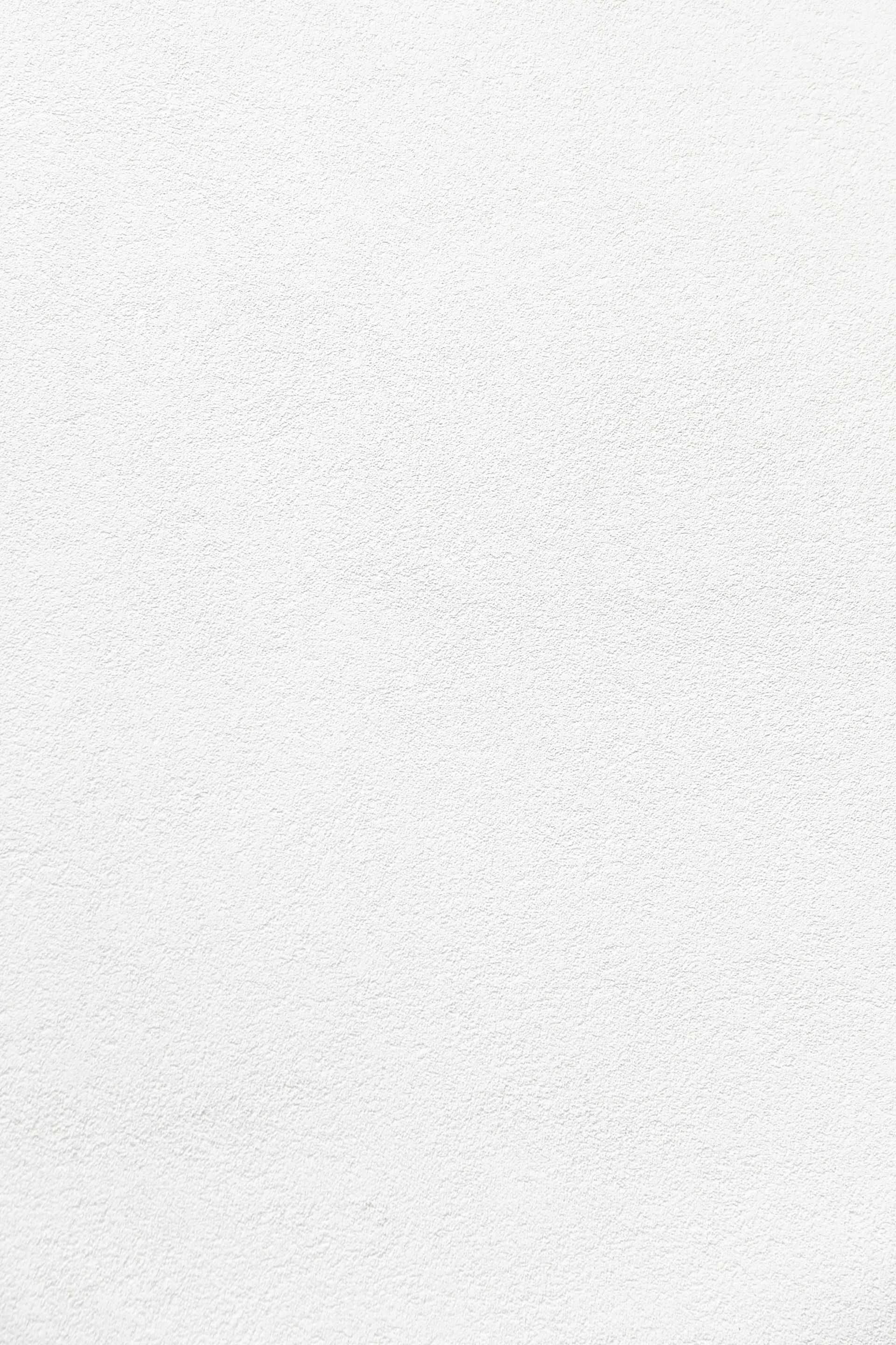 Light gray speckled textured surface with a slightly darker vertical edge on the right