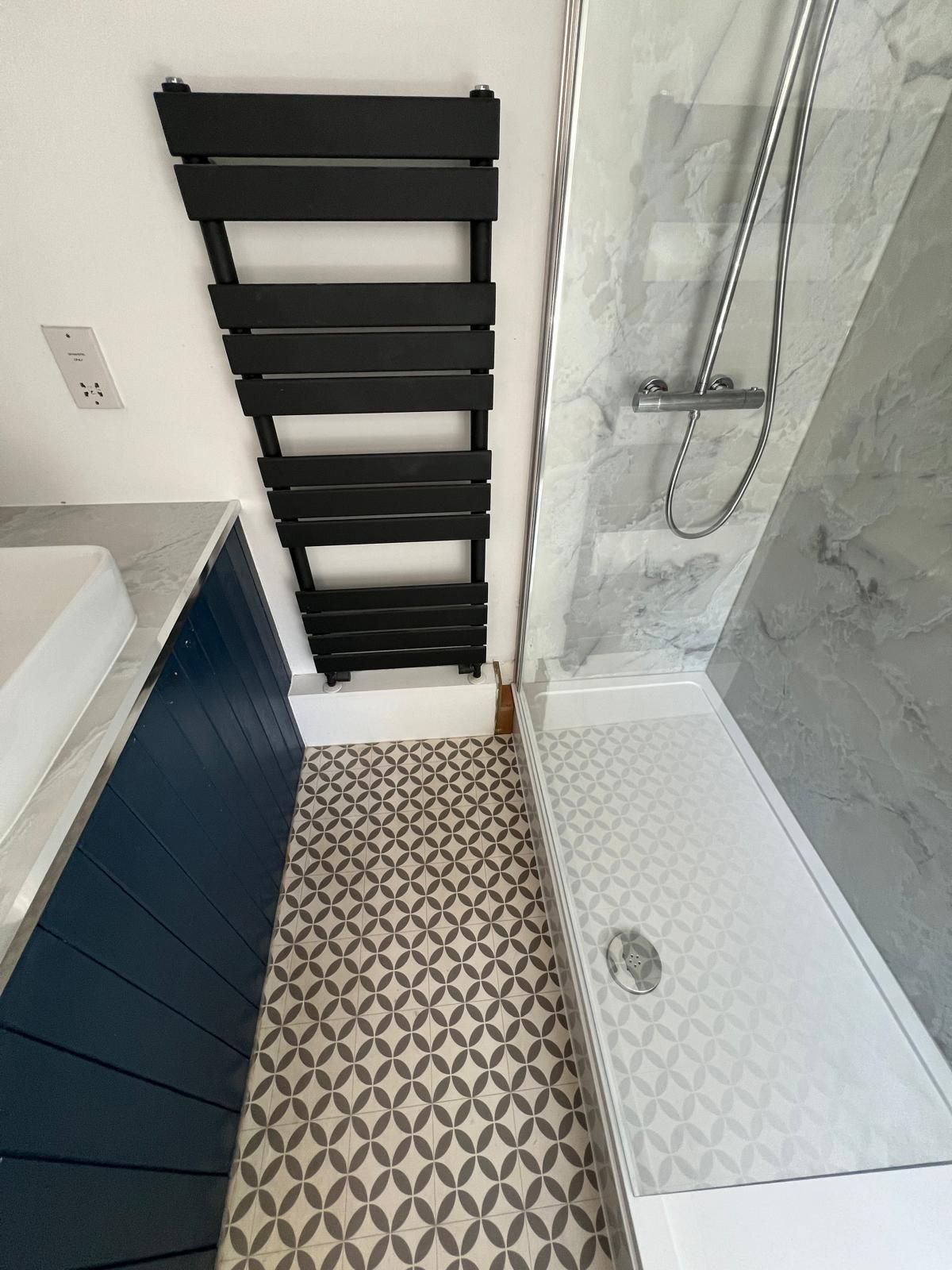 Black towel radiator fitted in a bathroom in Reading