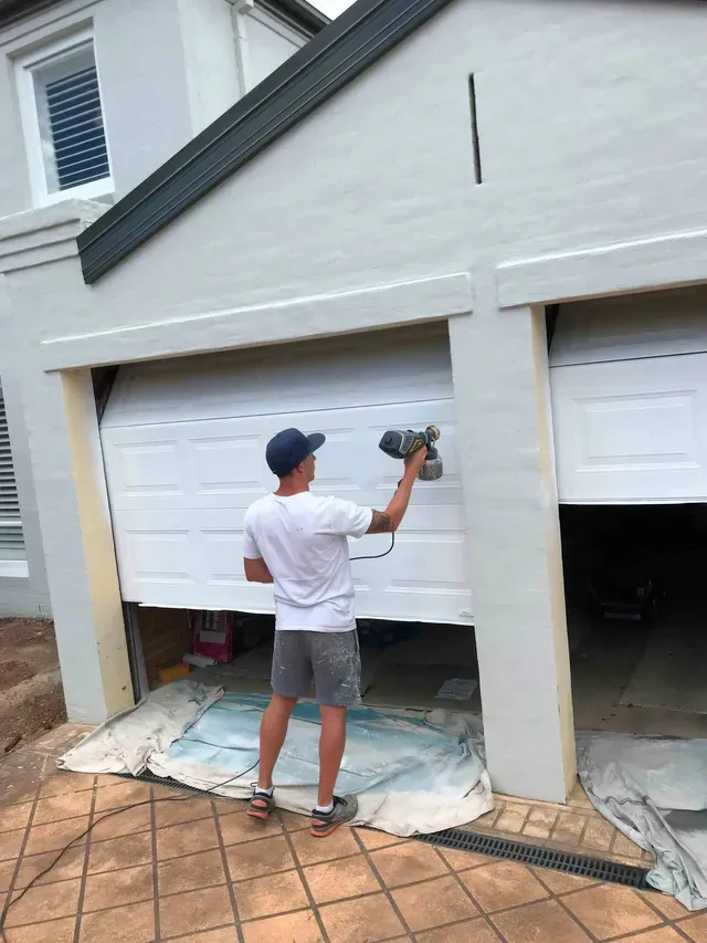 Man Painting Using Spray — Penrith, NSW — Bright Spots Painting & Decorating